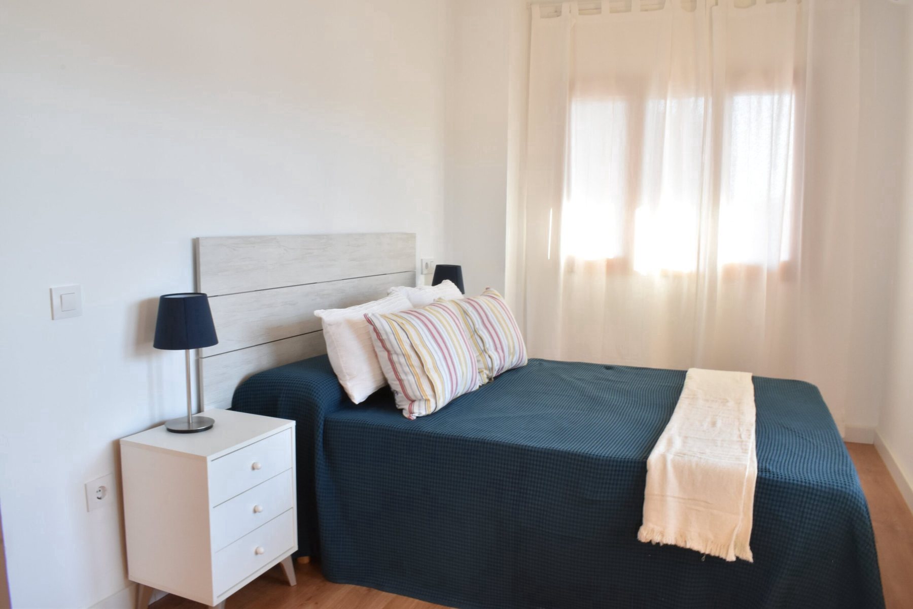 Habitación de matrimonio con colcha azul